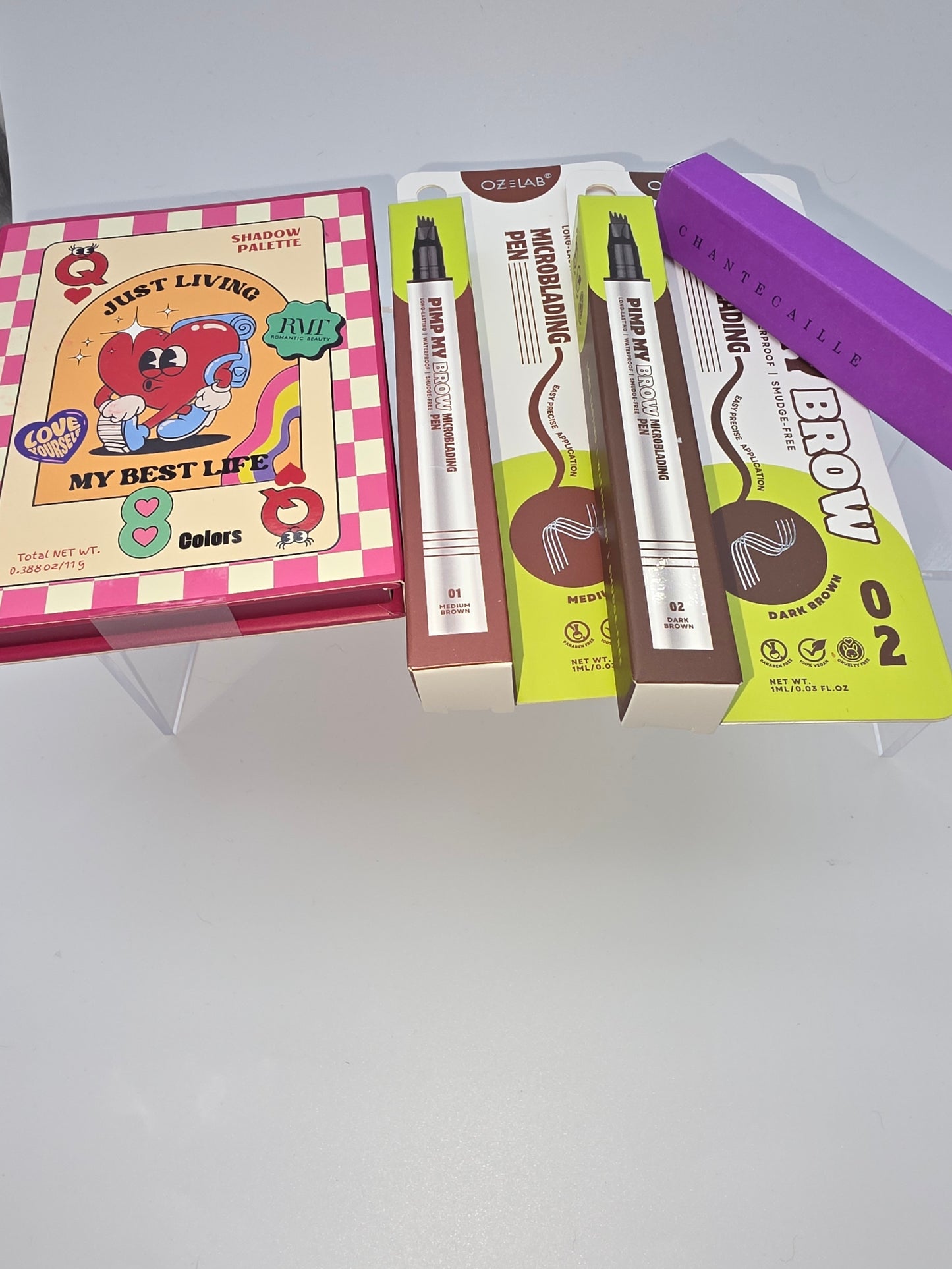 Just Living My Best Life Palette, OZELab Pimp My Brow Microblading Pens (Medium & Dark Brown), and Chantecaille Brightening Eye Kaja